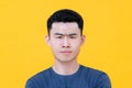 Close up of unhappy angry young Asian man face Royalty Free Stock Photo