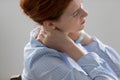 Close up unhappy businesswoman massaging neck, suffering from pain