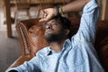 Close up unhappy depressed African American man lying on couch