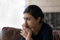 Close up unhappy Indian woman lost in thoughts, sitting alone Royalty Free Stock Photo