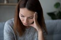 Close up of unhappy thoughtful woman lost in thoughts