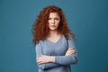 Close up of unhappy young girl with red wavy hair and freckles being angry and jealous seeing her boyfriend with other