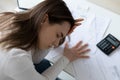 Close up unhappy young woman having head ache, checking finances Royalty Free Stock Photo