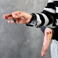 Close-up of unidentified hands of prisoner in prison stripped un Royalty Free Stock Photo