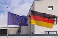 Close-up of the United Nations and Germany flags side-by-side in front of a white building