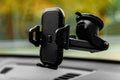 Close up of universal mount holder for smart phone on windshield.