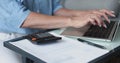 Closeup of unknown woman do accountancy, bookkeeping work using laptop