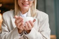 Close up of unrecognisable businesswoman holding cup of coffee while sitting in cafe Royalty Free Stock Photo