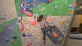 CLOSE UP: Unrecognizable agile woman climbs up an indoor bouldering route. Royalty Free Stock Photo