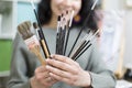 Close up of unrecognizable artist showing different types of brushes