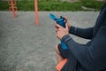 Close-up of an unrecognizable athlete holding a fresh water bottle rehydrating his body after exercise, bodybuilding and outdoor