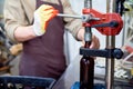 Close-up of brewing engineer using bottle capper at factory Royalty Free Stock Photo