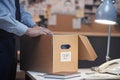 Close up of unrecognizable detective holding box with case files in office