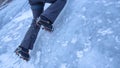CLOSE UP Alpinist sticks her crampons in the ice while climbing up frozen stream