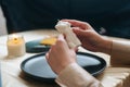 Close-up of unrecognizable female artisan putting on table ready to use handmade candle in shape of body of beautiful