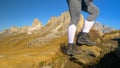 CLOSE UP: Unrecognizable female mountaineer hikes up hill overlooking Passo Giau Royalty Free Stock Photo