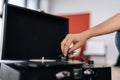 Close-up unrecognizable male hands adjusting head old record player and vinyl discs. Music lover man listening to Royalty Free Stock Photo