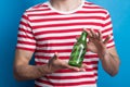 A close-up of an unrecognizable man in a studio holding an empty bottle. Royalty Free Stock Photo