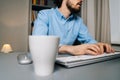 Close-up of unrecognizable man using computer and typing online message on wireless keyboard Royalty Free Stock Photo