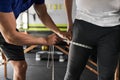 Close up unrecognizable personal trainer measuring thigh
