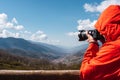 Close-up of unrecognizable photographer taking a photo of mountains landscape