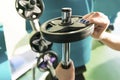 Close-up of strong woman preparing for workout training and adding extra weight plate for barbell Royalty Free Stock Photo