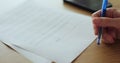 Close up unrecognizable woman filling a residential lease agreement, lease contract. Signing contract of purchase, sale Royalty Free Stock Photo