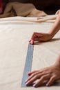 An unrecognizable woman is measuring fabric using rules Royalty Free Stock Photo