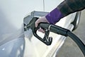 Close-up of unrecognizable woman putting petrol in her car.