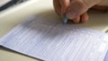 CLOSE UP: Unrecognizable woman reads and fills out immigration form on airplane. Royalty Free Stock Photo