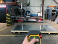 close-up of an unrecognizable worker using a remote control to use the suction cup machine to transport metal sheets