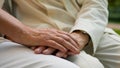 Close up unrecognizable wrinkled hand elderly old senior aged man and woman married couple husband wife holding hands Royalty Free Stock Photo