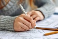 Close up unrecognizable young Caucasian right-handed female woman girl university student pupil hand holding pen writing Royalty Free Stock Photo