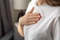 Close up of unrecognizable young woman having pain in heart area. Heart Attack, painful chest, health care and medical Concept. Royalty Free Stock Photo