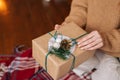 Close-up of unrecognizable young woman opening Christmas gift box with xmas present. Royalty Free Stock Photo