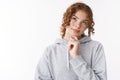 Close-up unsure cute redhead teenage girl thinking look up dreamy thoughtfully touching chin deciding what wear college Royalty Free Stock Photo