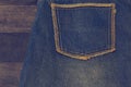 Close up up of fancy washed blue jeans pocket. On oak wood texture background, Ripped jeans of a stack Hipster fashion copy space Royalty Free Stock Photo