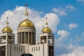 Close-up of the upper part of the modern five-headed church against the blue sky and clouds, selective focus Royalty Free Stock Photo
