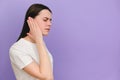 Close up of upset sad young caucasian woman holding painful ear, suddenly feeling strong ache, posing isolated on violet color Royalty Free Stock Photo