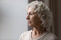 Close up upset thoughtful mature senior woman looking out window Royalty Free Stock Photo