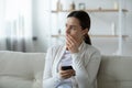 Close up upset unhappy young woman holding smartphone