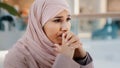 Close-up upset young woman gets bad news feels stressful anxiety frustrated muslim girl suffers from headache grabs head