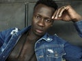 Young handsome and attractive athletic black African American man in open denim shirt showing tattoo muscular torso posing in cool Royalty Free Stock Photo