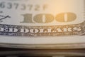 Close up on US dollar banknotes. Depth of field Number 100 on US Dollar banknotes with warm light. Shooting by 1:1 Macro lense. I Royalty Free Stock Photo