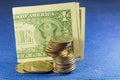 Close up of us dollars and coins for currency exchange on blue background Royalty Free Stock Photo