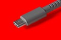 Close-up of USB Type-C cable on red background. Royalty Free Stock Photo