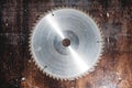 Close-up used blade circular saw on the background of the wooden table. Workshop for the production of wooden products Royalty Free Stock Photo