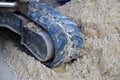 close-up used and dirty Rubber caterpillar bulldozer. Close up Excavator crawler belt in construction site