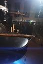 Close-up of used drumsticks lie on a drummer`s chair against the background of a drum kit and flare of spotlights. The Royalty Free Stock Photo