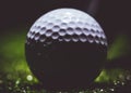 Close up of a used golf ball on a dark background